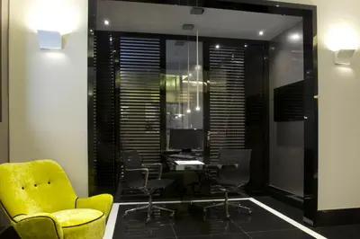 an office with a yellow chair and a desk and chairs at Mood44 in Rome