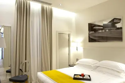 a bedroom with a bed with a tv on the wall at Mood44 in Rome