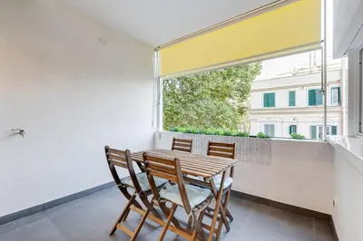 a dining room with a table and chairs and a window at Giulio Cesare Apartment in Rome