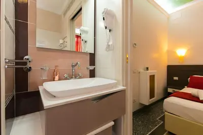 a bathroom with a sink and a bed at Anthony 47 in Rome