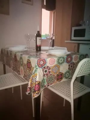 a table with a bottle of wine sitting on top of it at Gisa Apartment in Rome