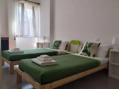 a living room with a tv and a chair and a window at Aurelia Begonia Apartment - family & business in Rome