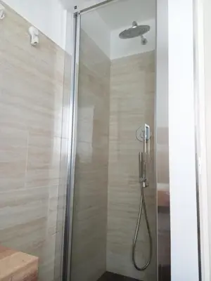 a shower in a bathroom with a glass door at LIVING ROME Int 2 in Rome