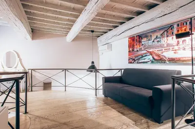 a living room with a couch and a painting on the wall at Restart Accommodations Borghese in Rome