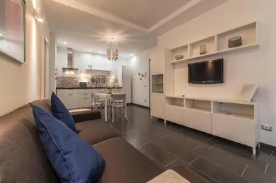 a living room with a couch and a kitchen at Romantic Apartment in Rome, 50 sqm, Parking in Rome