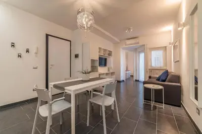 a kitchen and living room with a table and chairs at Romantic Apartment in Rome, 50 sqm, Parking in Rome