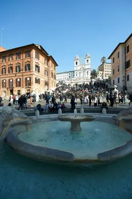 a group of people sitting around a fountain at Harry's Bar Trevi Luxury Apartments - Spagna in Rome