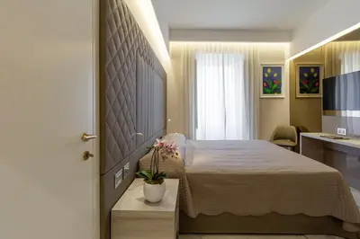 a hotel room with a bed and a television at Harry's Bar Trevi Luxury Apartments - Spagna in Rome