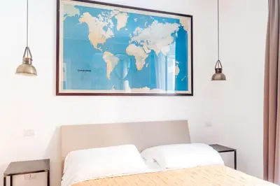 a bedroom with a map of the world on the wall at Restart Accommodations Aldobrandini e Sciarra in Rome