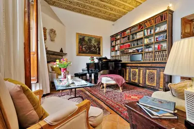 a living room with a table and a piano at TreasureRome Daphne Terrace in Rome
