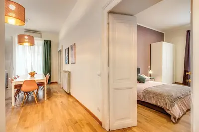 a bedroom with a bed and a table and a desk at Diocleziano Triple in Rome