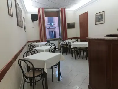 a restaurant with white tables and chairs and a window at Hotel Ferrari in Rome