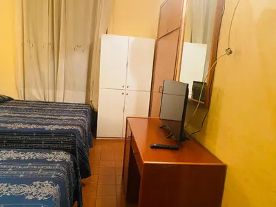 a hotel room with a desk with a computer on it at Hotel Ferrari in Rome