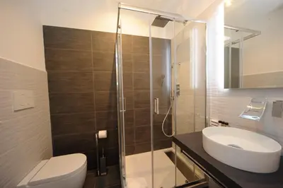 a bathroom with a shower and a toilet and a sink at My Suites Piazza di Spagna in Rome