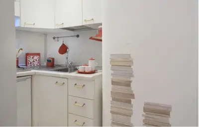 a kitchen with a sink and a stack of books at La casa di Remo in Rome