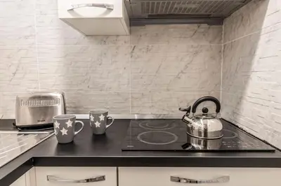 a kitchen with a stove and two cups on a counter at GuestHouse near St.Peter in Rome