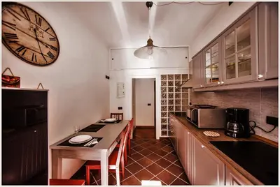 a kitchen with a large clock on the wall at Accogliente appartamento a Testaccio in Rome