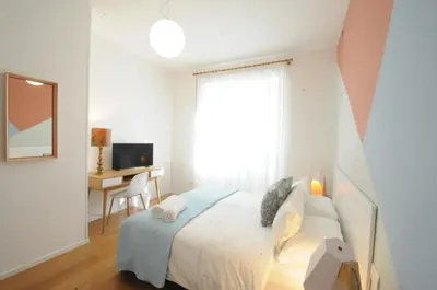 a bedroom with a bed with a desk and a window at Viaggio da Bea al Gianicolo in Rome