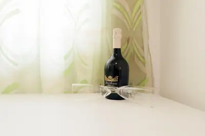 a bottle of wine sitting on a shelf at TIBURTINA INN GUEST HOUSE in Rome
