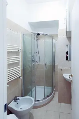 a bathroom with a shower and a toilet and a sink at TIBURTINA INN GUEST HOUSE in Rome