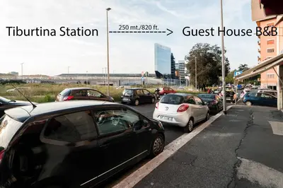 a bunch of cars parked in a parking lot at TIBURTINA INN GUEST HOUSE in Rome
