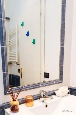 a bathroom sink with a large mirror above it at Magik rooms in Rome