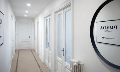 a hallway with white walls and a round mirror at Guardabassi Collection - Vatican White by Varental in Rome