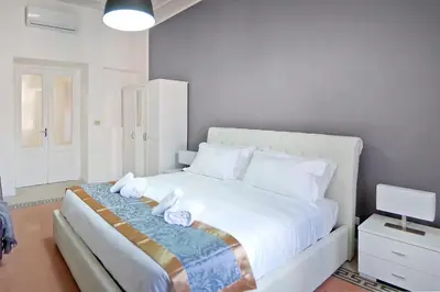 a bedroom with a white bed with towels on it at Guardabassi Collection - Vatican White by Varental in Rome