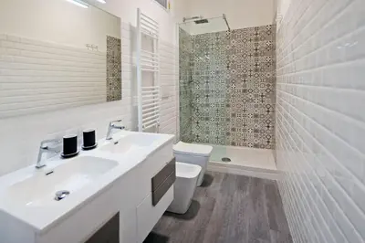 a white bathroom with a sink and a shower at Guardabassi Collection - Vatican White by Varental in Rome