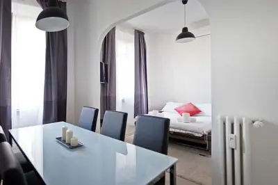a dining room with a table and chairs and a bed at Guardabassi Collection - Vatican White by Varental in Rome