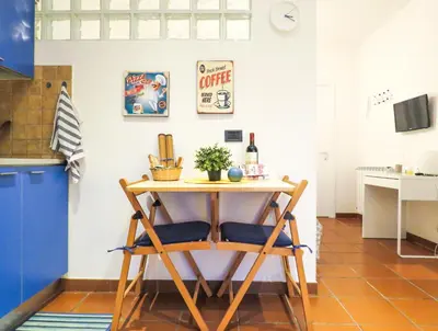 a small table in a kitchen with a blue and white wall at Casa Sofia - beauty apartment close Vatican Museum in Rome