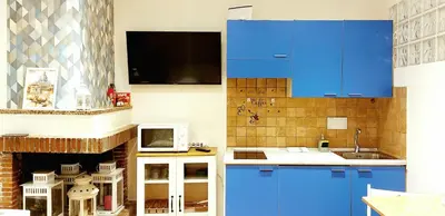 a kitchen with blue cabinets and a microwave at Casa Sofia - beauty apartment close Vatican Museum in Rome