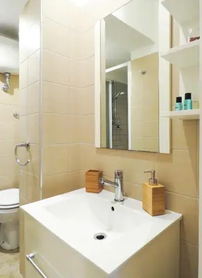 a bathroom with a sink and a mirror and a toilet at Casa Sofia - beauty apartment close Vatican Museum in Rome