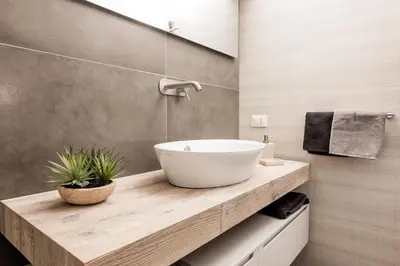 a bathroom with a white bowl sink on a wooden counter at Casa Prati Michelangelo in Rome