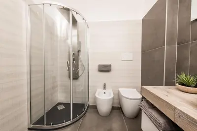 a bathroom with a glass shower and a toilet at Casa Prati Michelangelo in Rome
