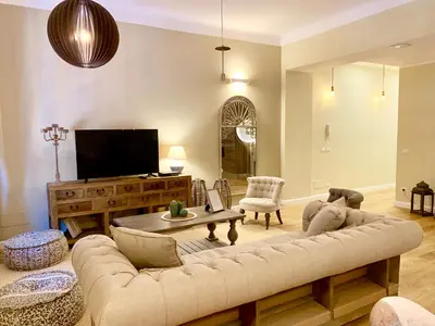 a living room with a couch and a tv at Frattina Luxury House in Rome