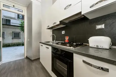 a kitchen with a sink and a stove top oven at Casa Calpurnia in Rome