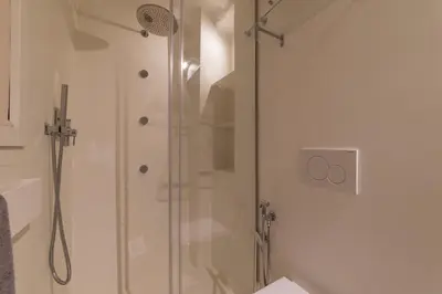 a shower with a glass door in a bathroom at Campo De' Fiori Apartment - Charme Holidays in Rome