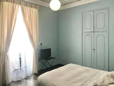 a bedroom with a bed and a window at B&B Santi Quattro Al Colosseo in Rome