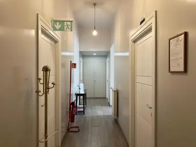 a hallway with two doors and a room with a hallway at B&B Santi Quattro Al Colosseo in Rome