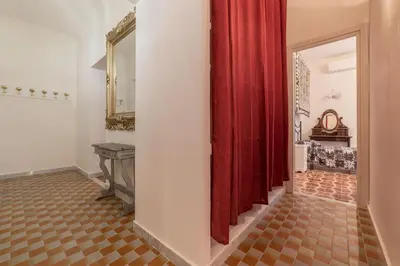 a hallway with red curtains and a hallway with a table at GuestHost - Piramide & Testaccio Design Flat in Rome