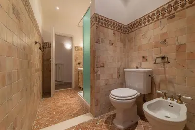 a bathroom with a toilet and a shower and a sink at GuestHost - Piramide & Testaccio Design Flat in Rome