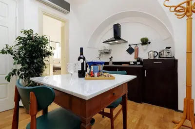 a kitchen with a table with a bottle of wine at Restart Accommodations Celimontana in Rome