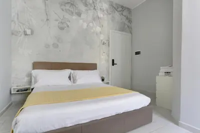 a bedroom with a large bed with a yellow blanket at Voyager House Termini - Home and More in Rome