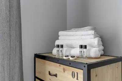 a pile of towels sitting on top of a dresser at Voyager House Termini - Home and More in Rome
