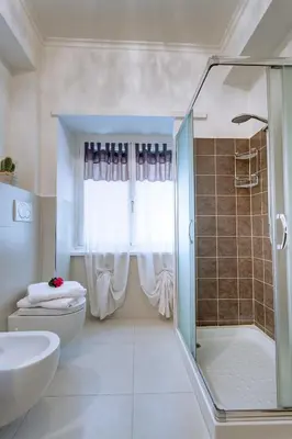 a bathroom with a shower and a toilet and a sink at Elements Guest House Roma in Rome
