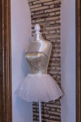a dress on a mannequin in front of a brick wall at Rifugio degli Artisti B&B in Rome