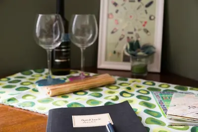 a table with two wine glasses and a napkin at New Suite Amèlie in Rome
