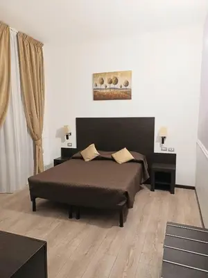 a bedroom with a large bed and two night stands at Leone in Rome