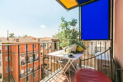 a balcony with a table and a view of a city at Appartamenti MarcoAurelio49 in Rome
